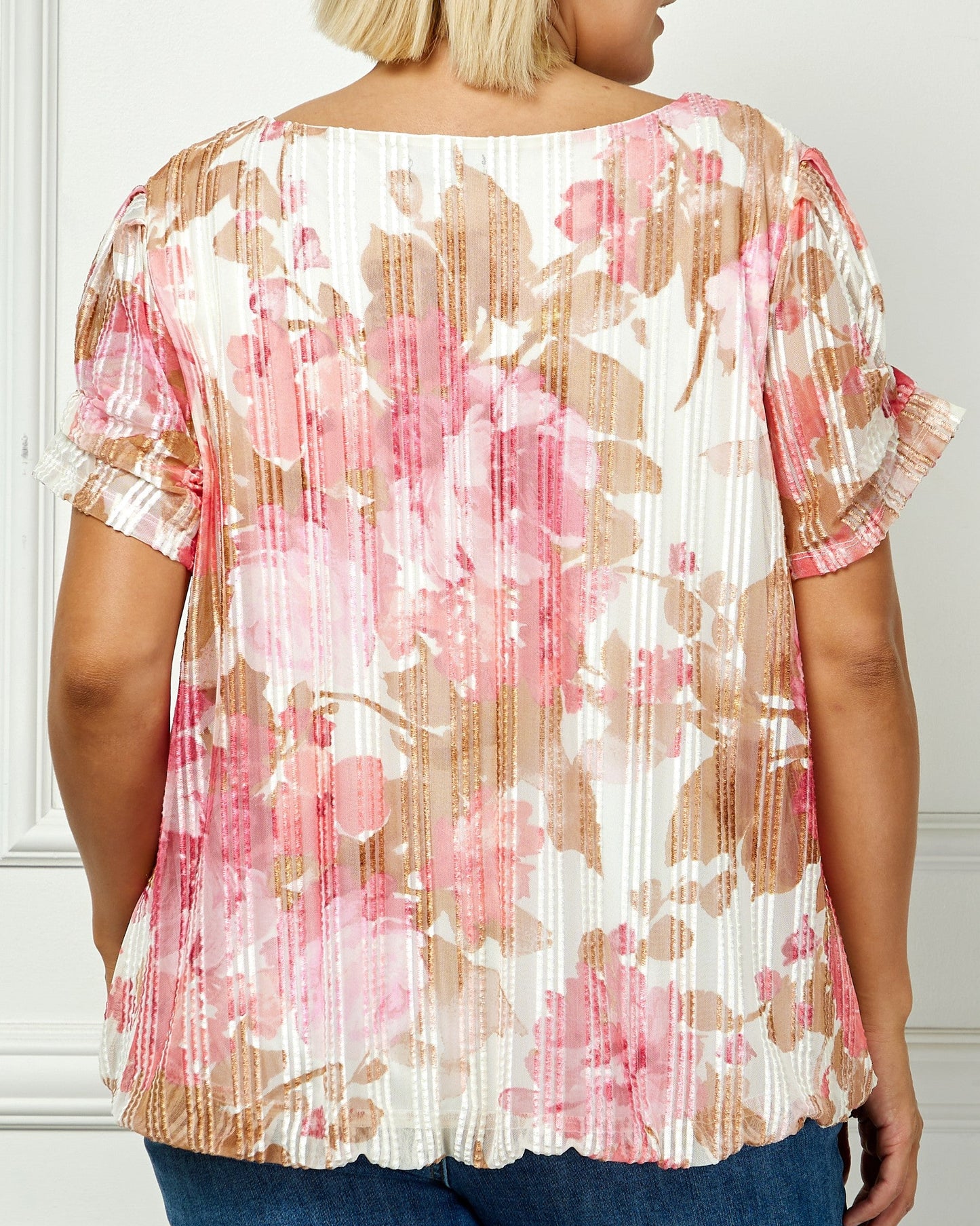 Woman wearing a floral blouse with a white background