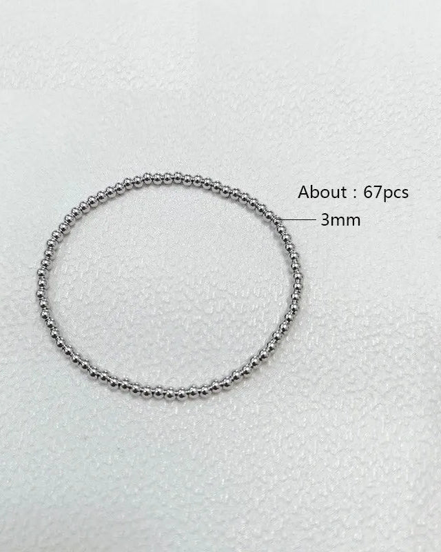 Silver beaded bracelet on a light gray background with measurements indicated.