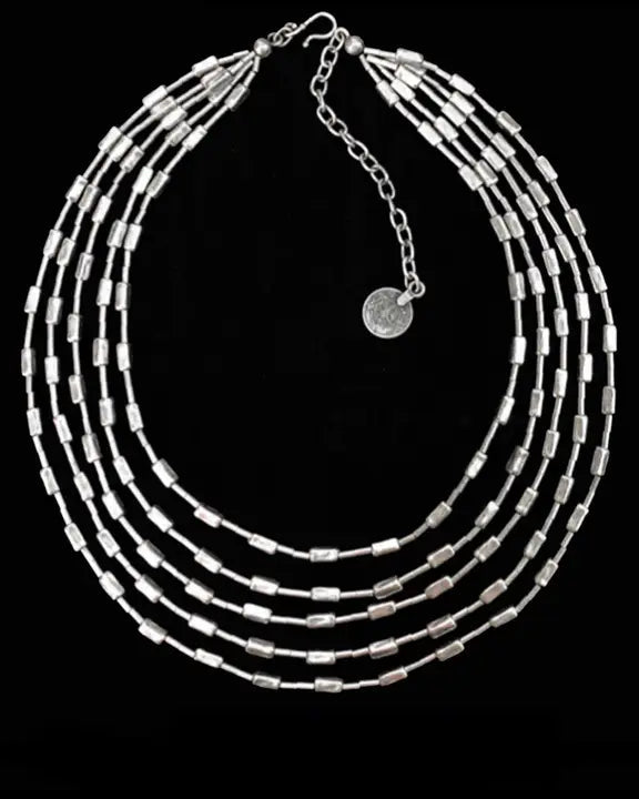 Silver beaded necklace on a black background