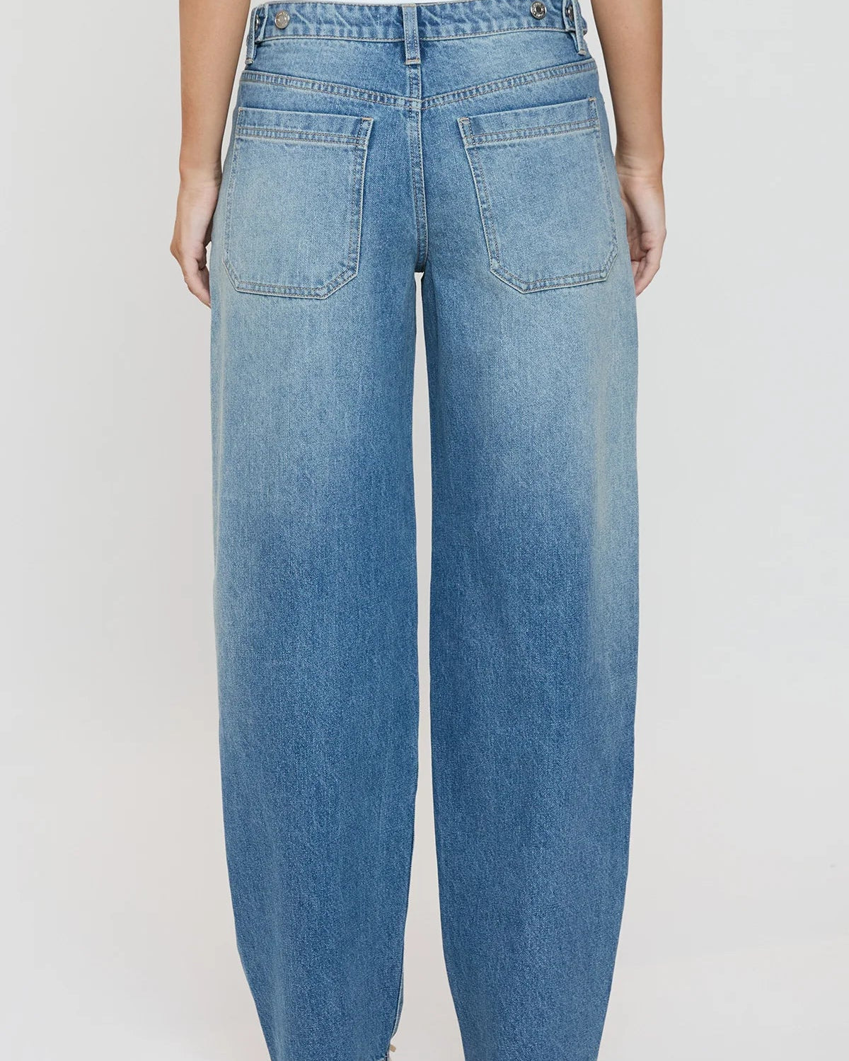 Light blue jeans worn by a person on a white background