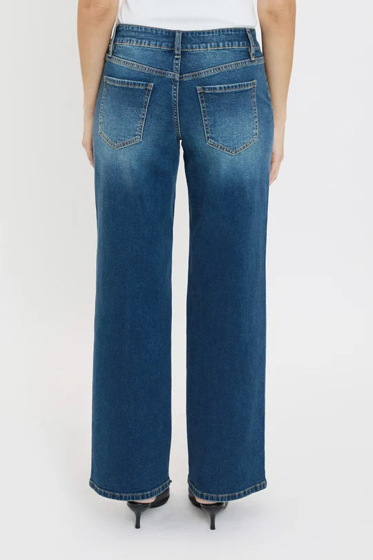 Blue jeans worn by a person on a white background