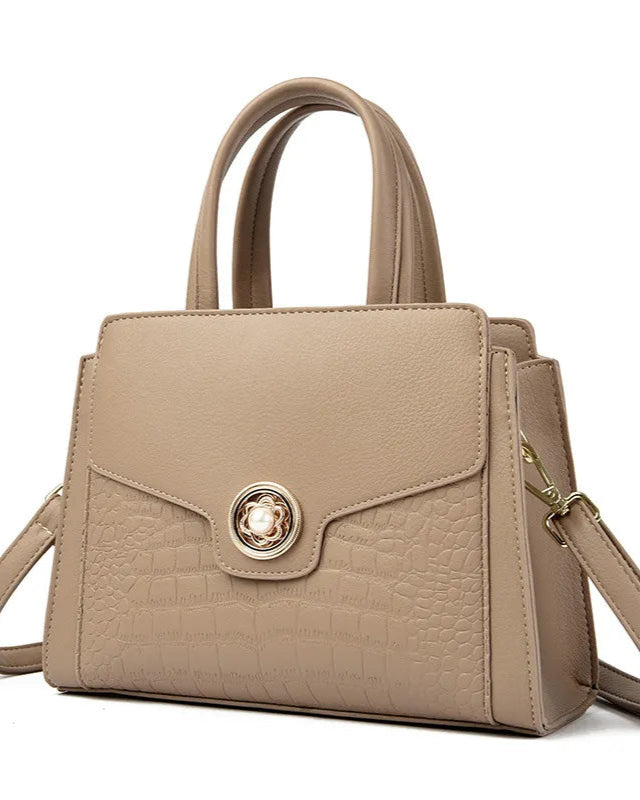 Beige handbag with a gold clasp on a white background