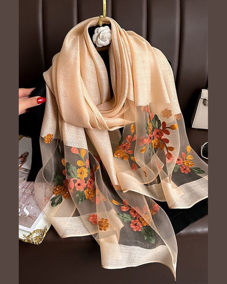 Beige scarf with floral patterns draped over a chair