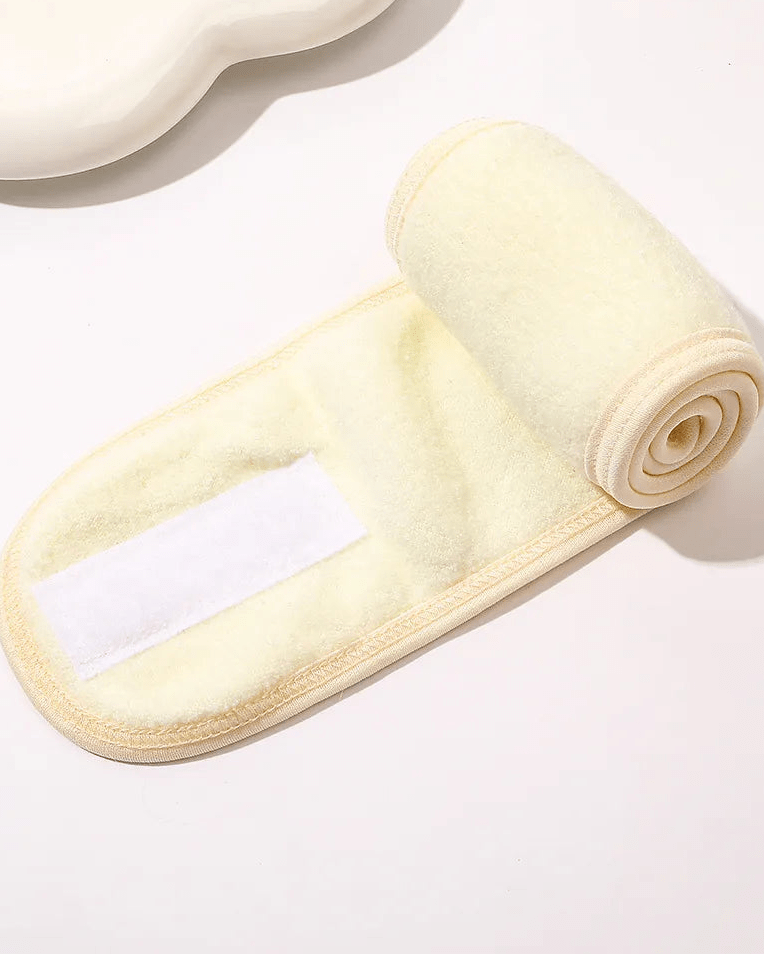 Roll of cream-colored fabric on a white background