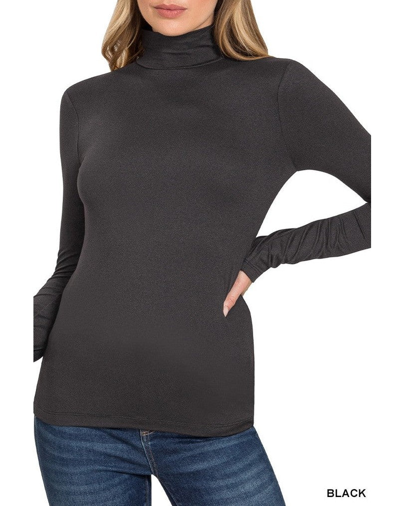 Woman wearing a black turtleneck sweater with long sleeves on a white background