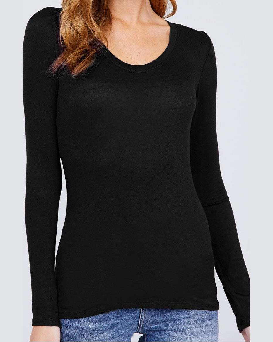 Woman wearing a black long-sleeve top against a white background