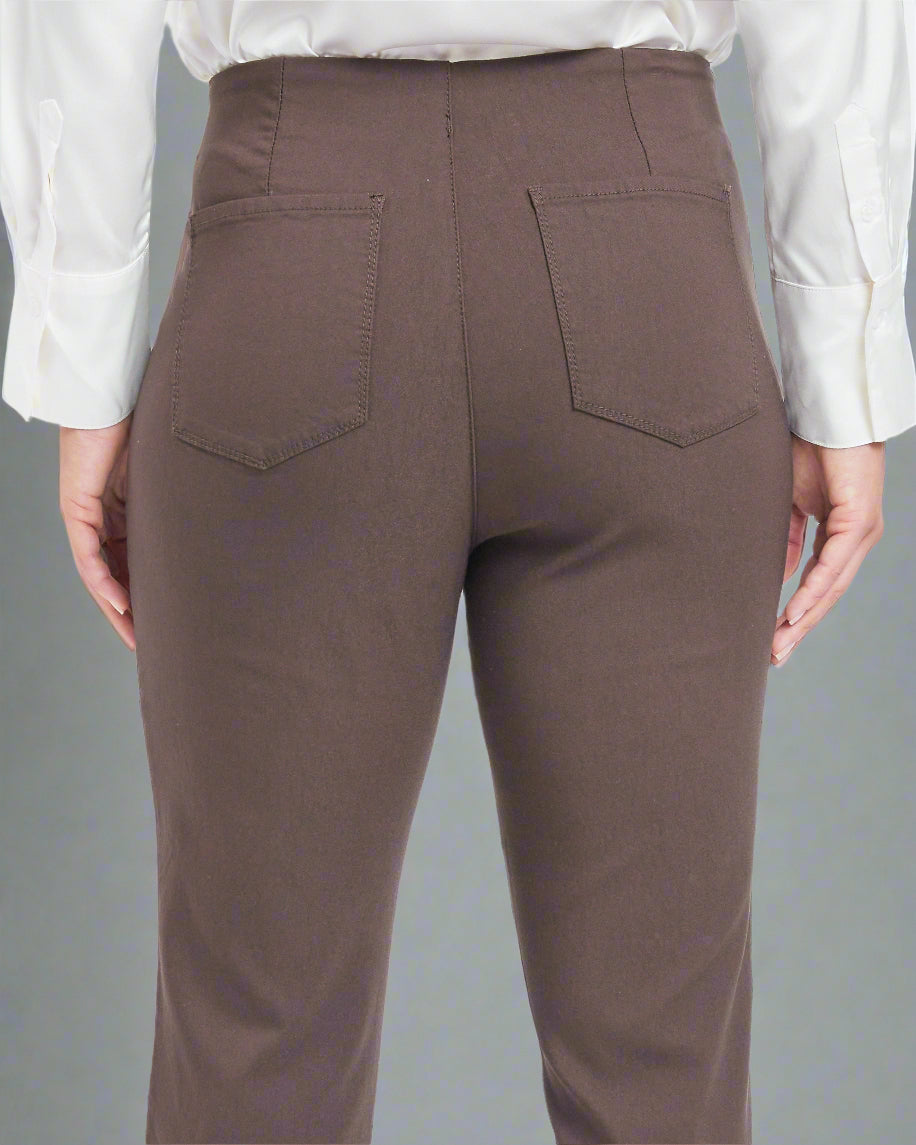 Brown flared pants worn by a person on a white background