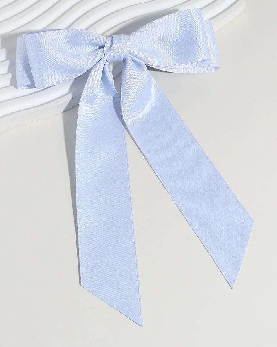 Large satin hair bow with barrette clip shown flat