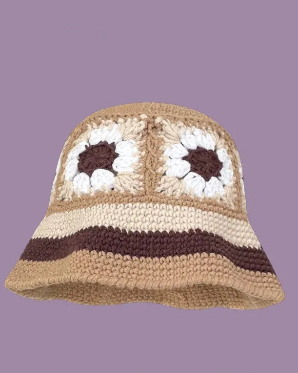 Crocheted hat with floral patterns on a purple background