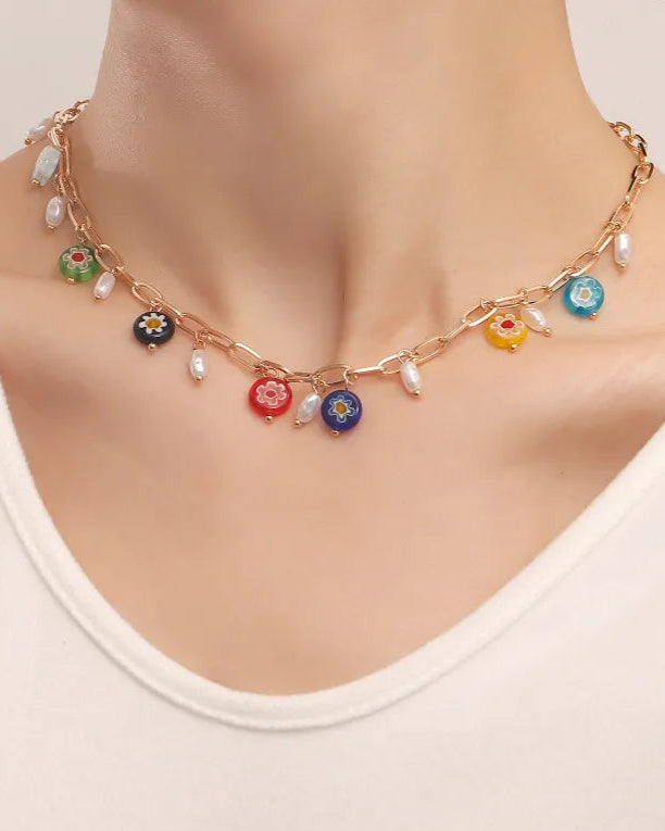 On Model: Multicolor charm necklace worn with white top