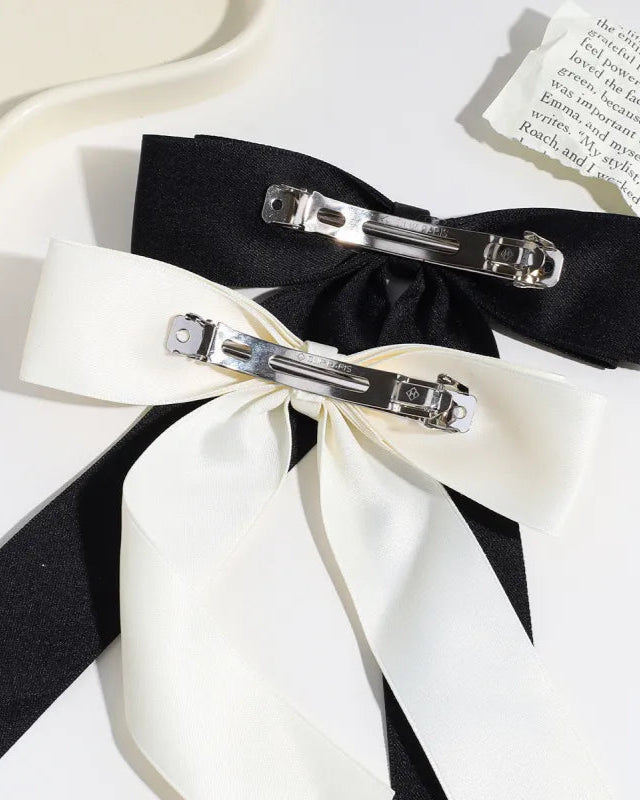 Large satin hair bow with barrette clip shown flat