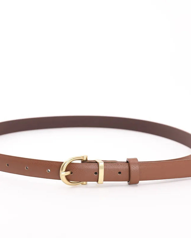 Close-up of gold square pin buckle and belt holes