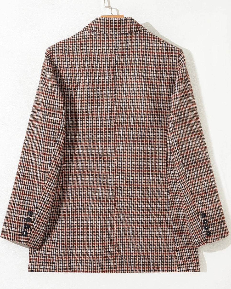 Plaid jacket on a hanger against a white background