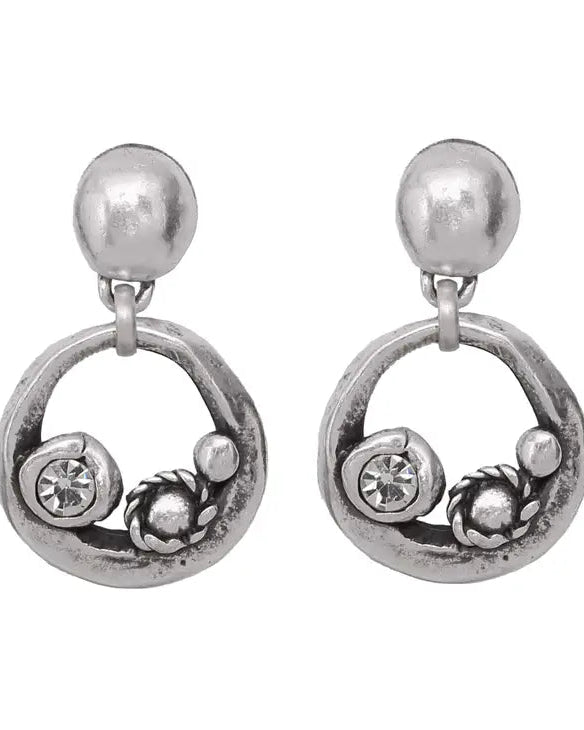 Pair of silver earrings with circular design and embedded stones on a white background