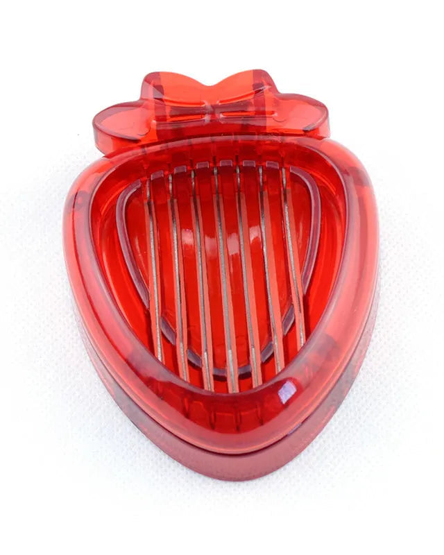 Red heart-shaped object with a bow on top against a white background