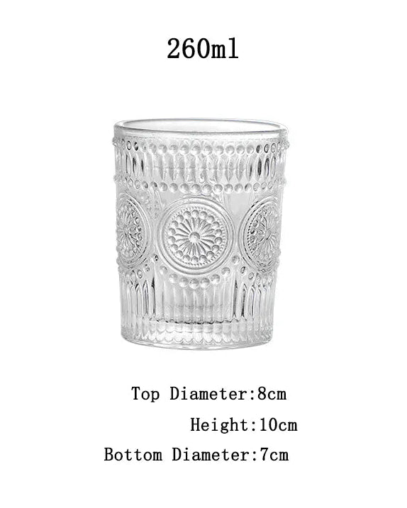 Clear glass tumbler with decorative patterns on a white background, showing measurements.