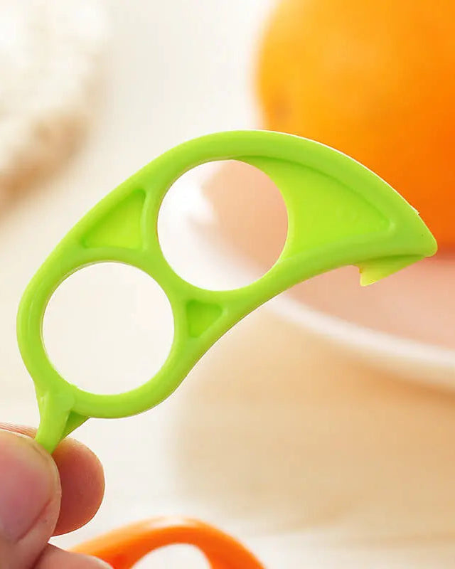 Green kitchen tool held by a hand with a blurred background