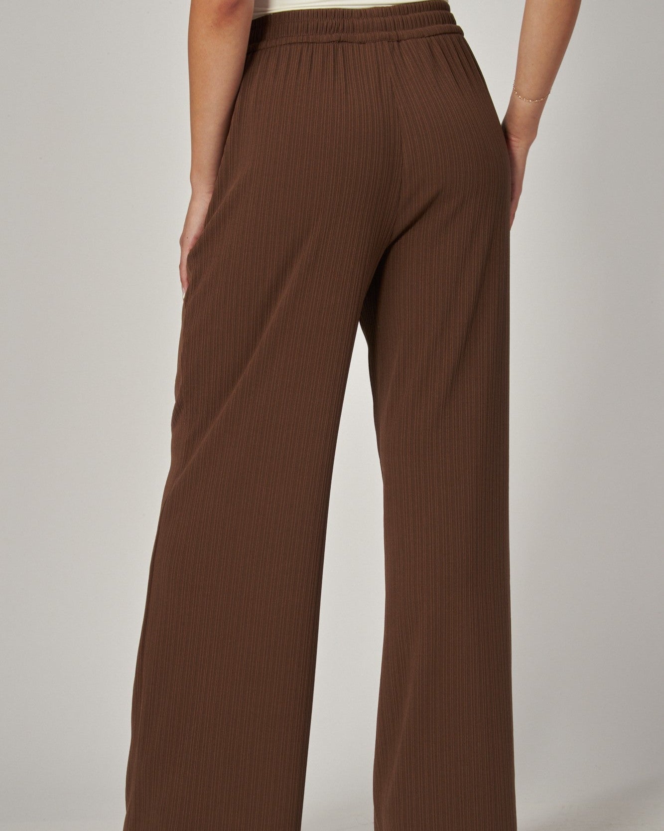 Brown wide-leg pants worn by a person on a plain background