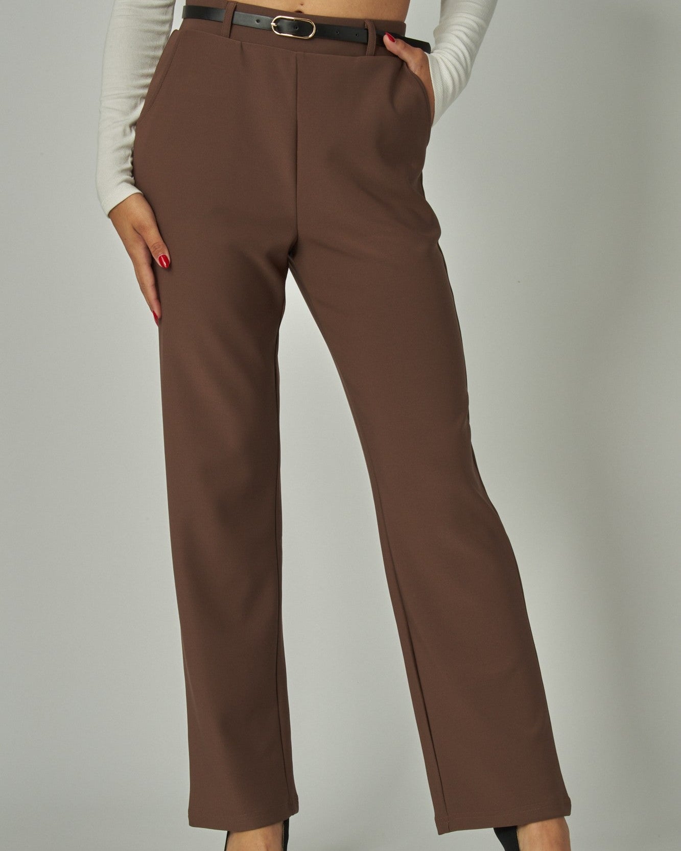 Brown pants worn by a person on a plain background