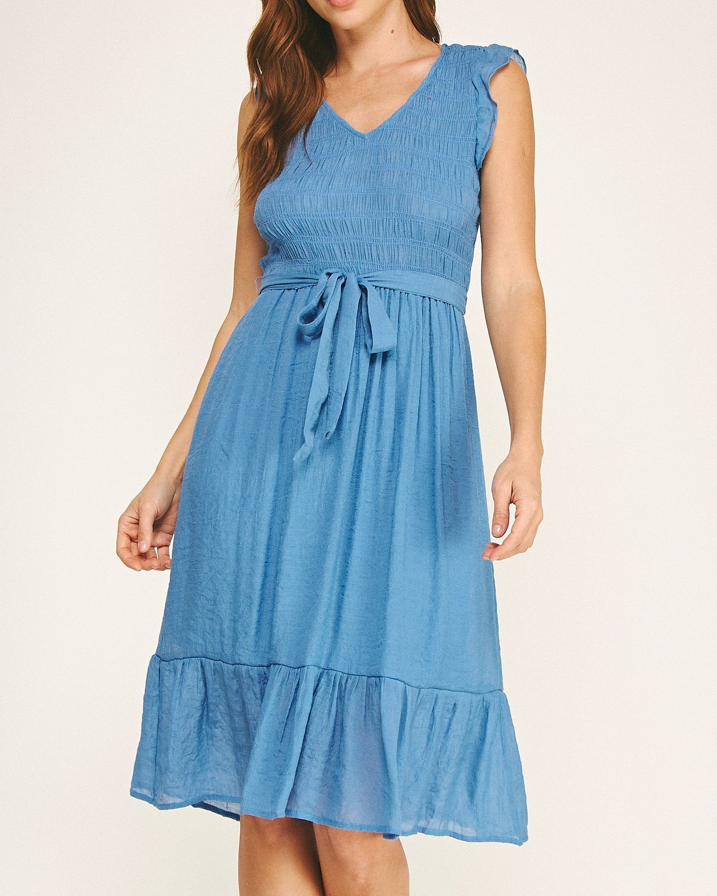 Woman wearing a blue dress on a white background