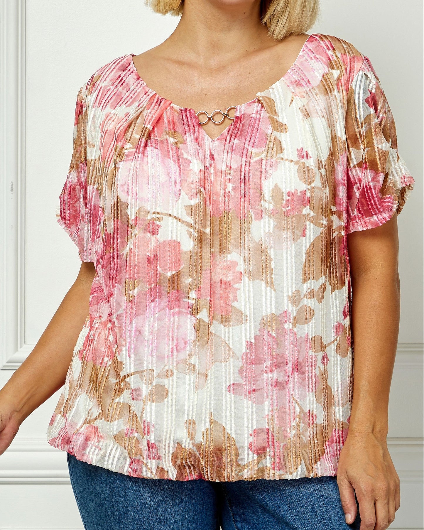 Woman wearing a floral blouse with a plain background