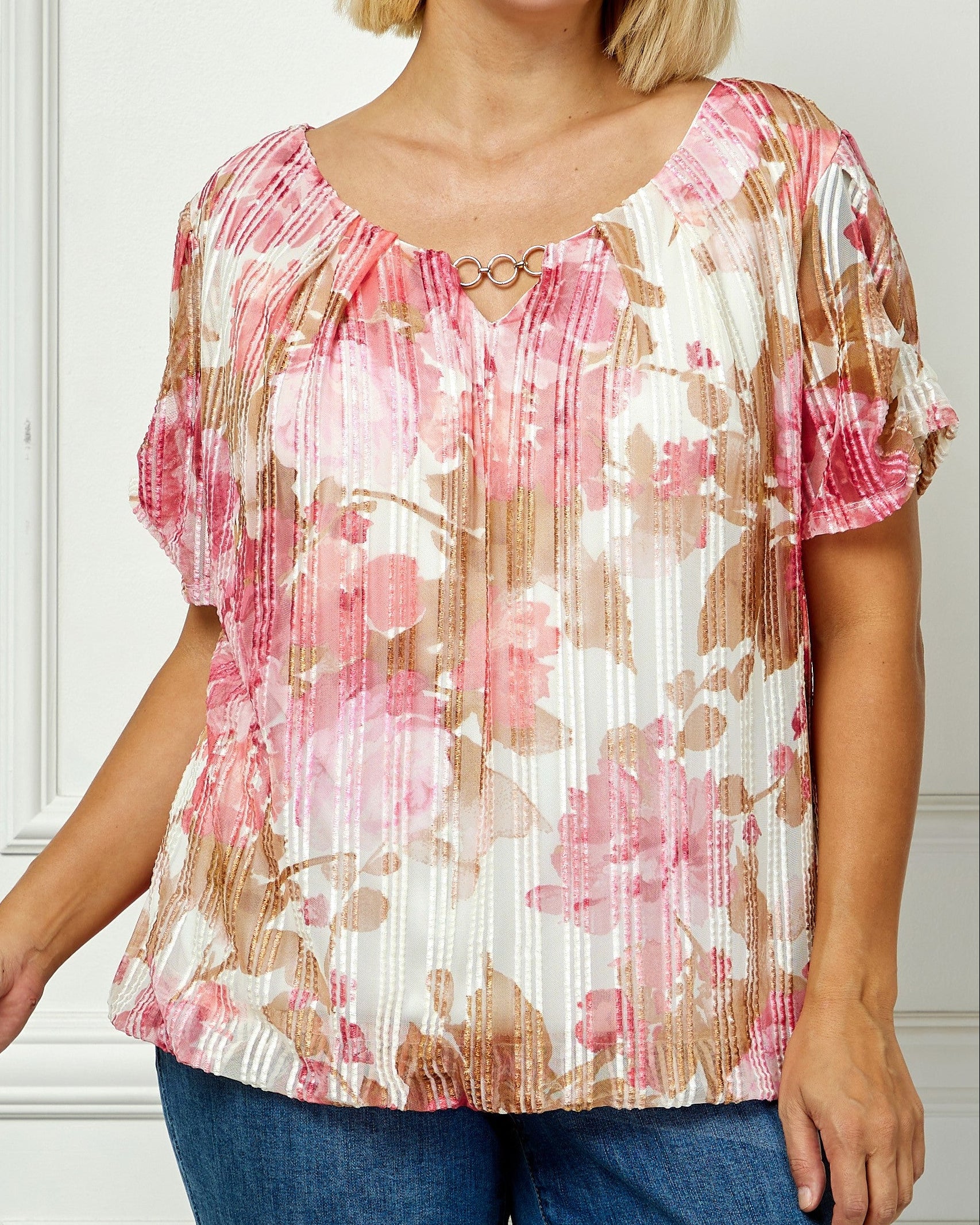 Woman wearing a floral blouse with a plain background