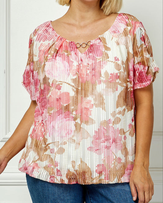 Woman wearing a floral blouse with a plain background
