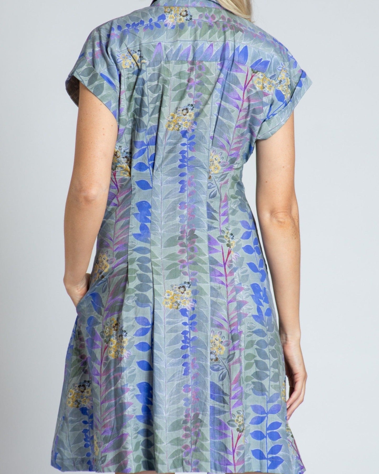 Woman wearing a floral dress with a plain background