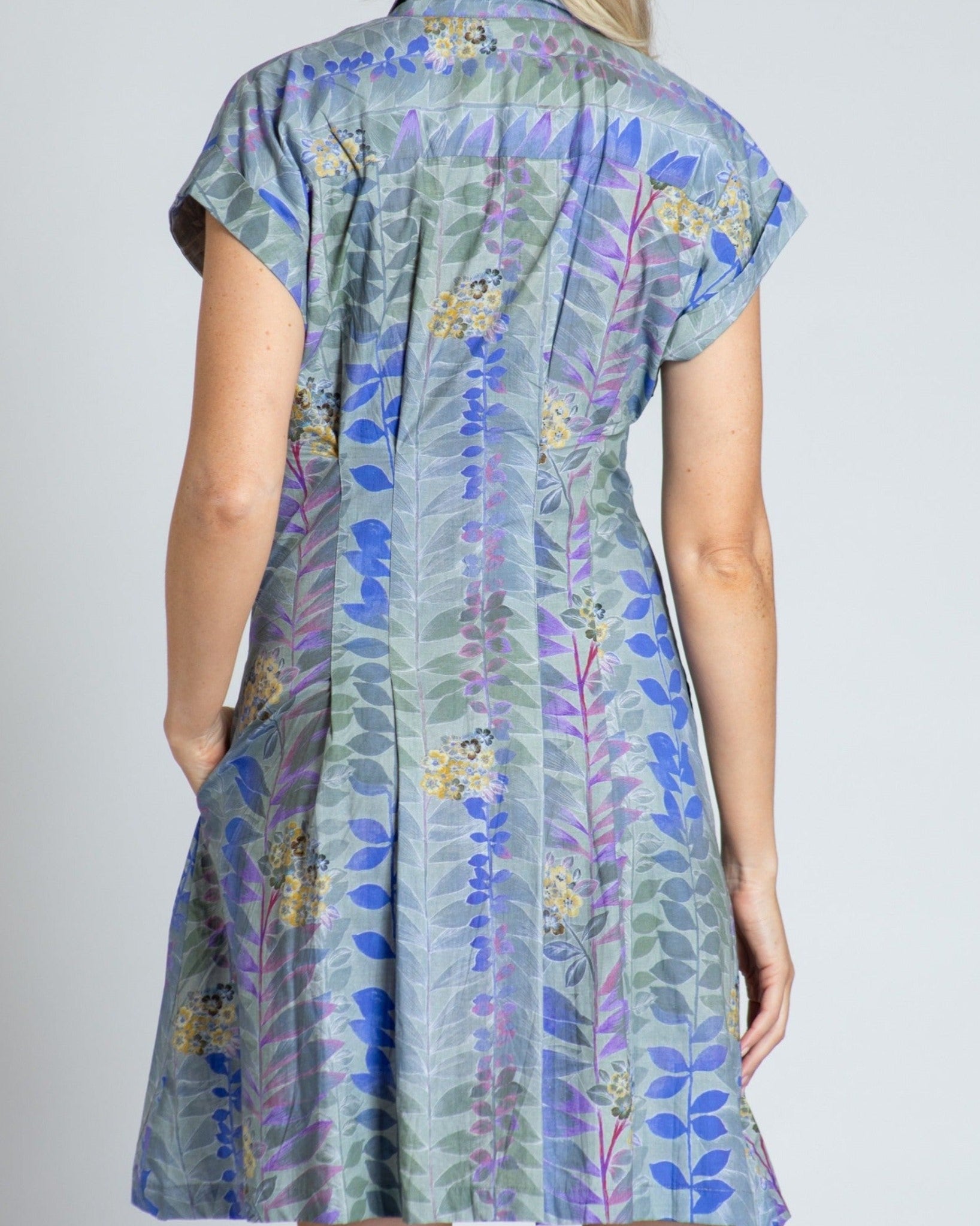 Woman wearing a floral dress with a plain background