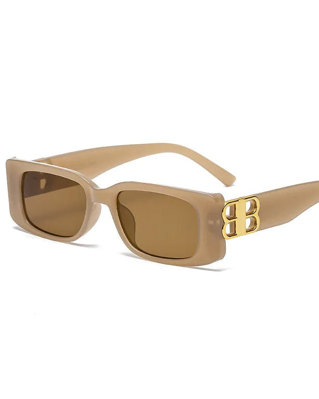 Beige sunglasses with a gold logo on a white background