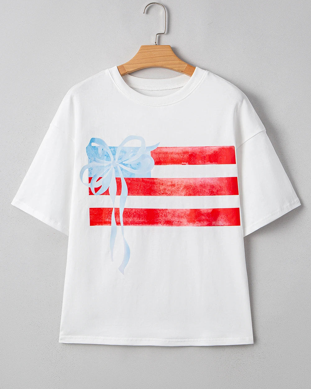 White t-shirt with red and blue graphic on a gray background
