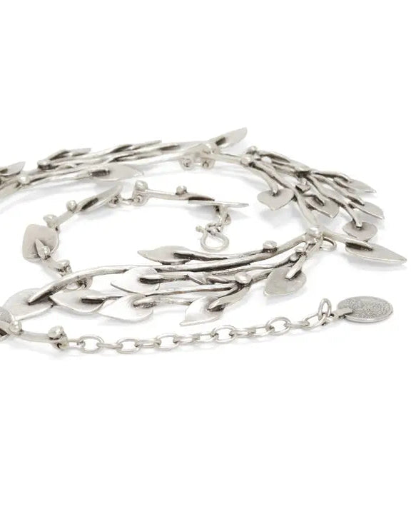 Silver necklace with leaf-like designs on a white background