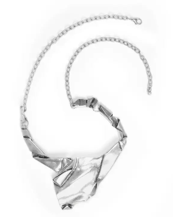 Silver necklace with a geometric pendant on a white background