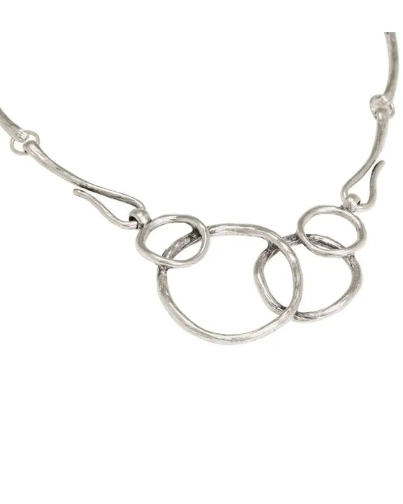 Silver necklace with interlocking rings on a white background