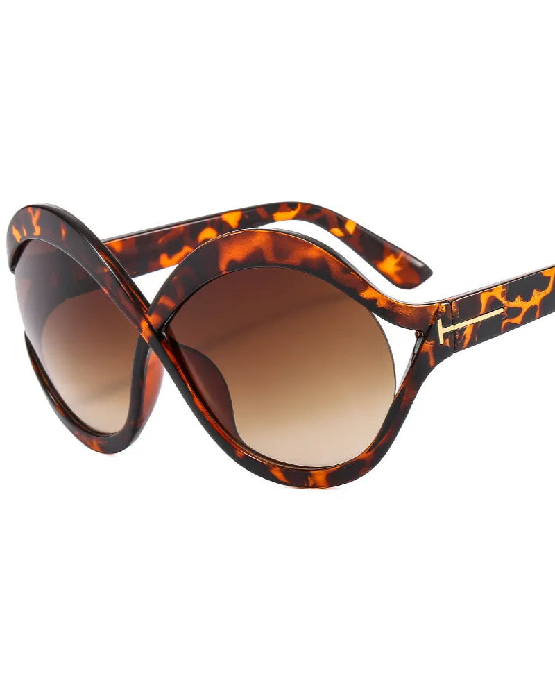 Sunglasses with tortoiseshell frame and brown lenses on a white background
