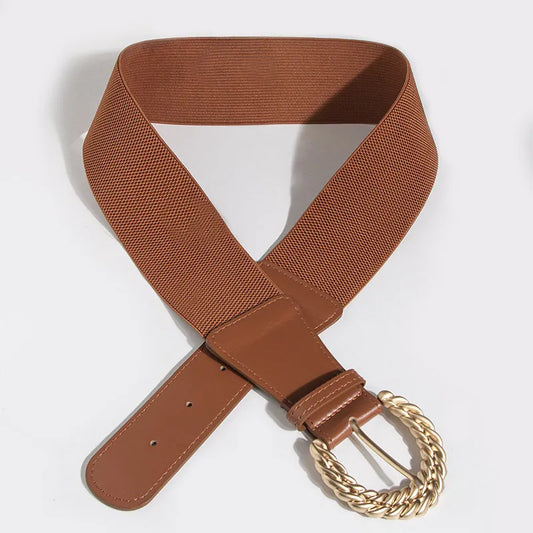 Brown belt with a gold buckle on a light gray background