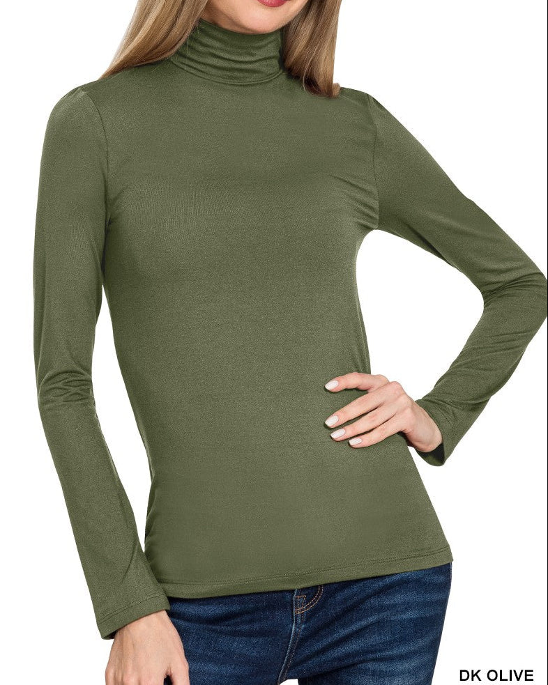 Woman wearing a green turtleneck sweater on a white background