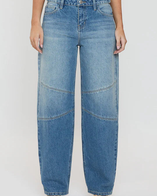 Person wearing blue jeans on a white background