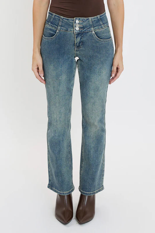 Person wearing blue jeans on a white background