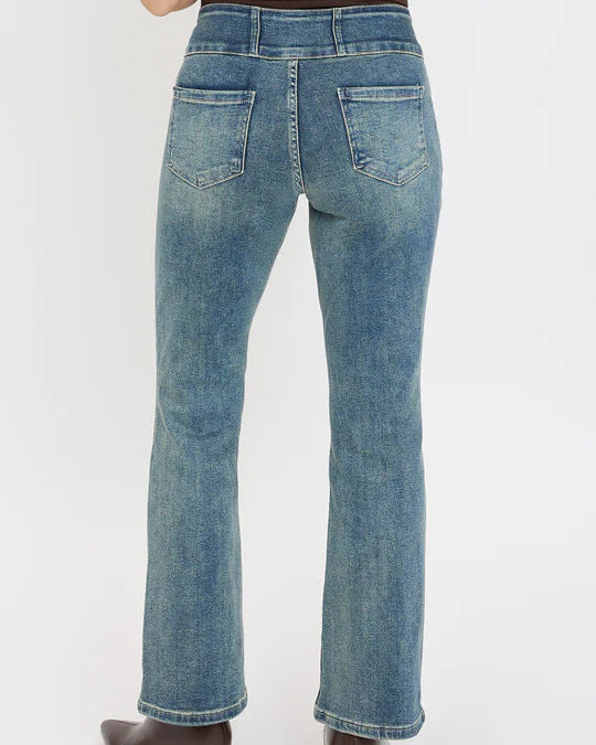 Person wearing blue jeans on a white background