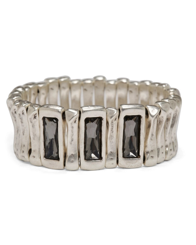 Silver ring with rectangular gemstones on a white background