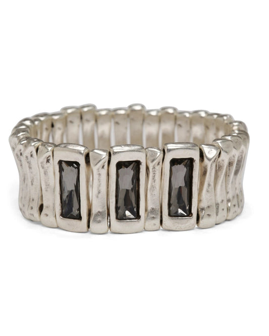 Silver ring with rectangular gemstones on a white background