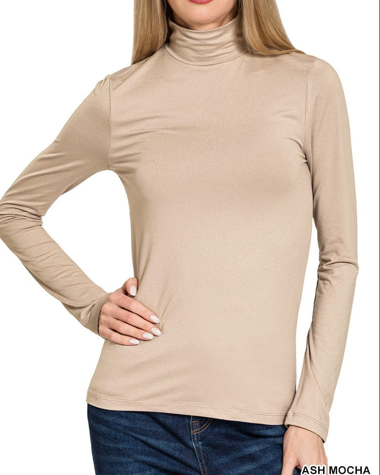 Woman wearing a beige turtleneck shirt on a white background