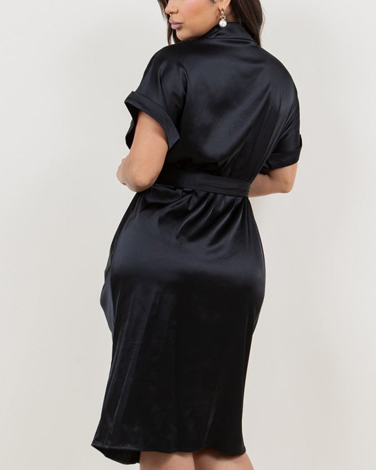 Woman wearing a black satin dress against a white background