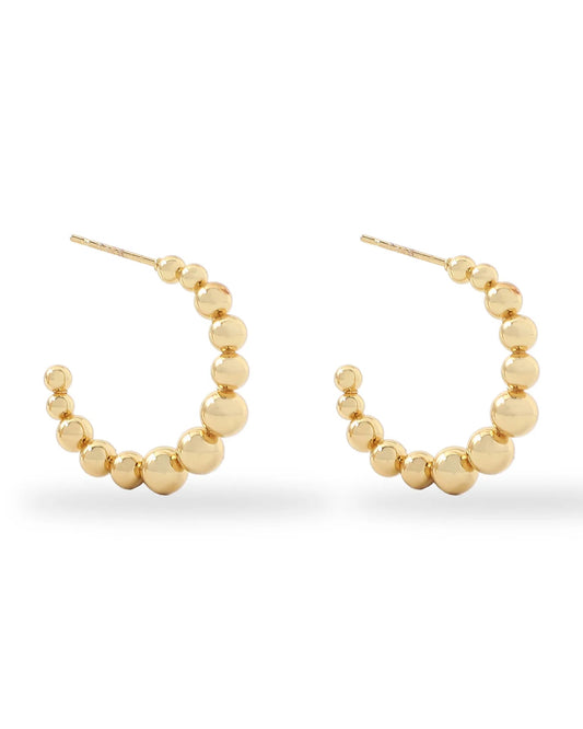 Gold hoop earrings with bead detailing on a white background