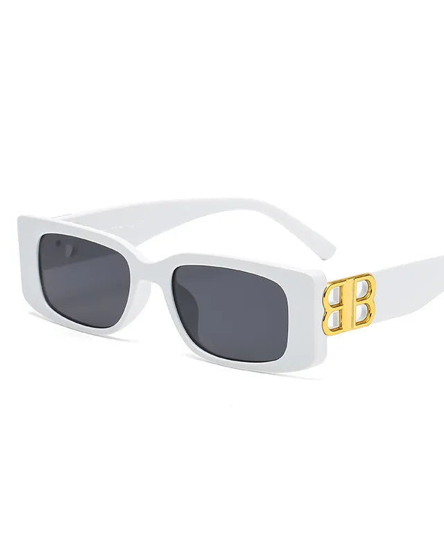 White sunglasses with gold accents on a white background