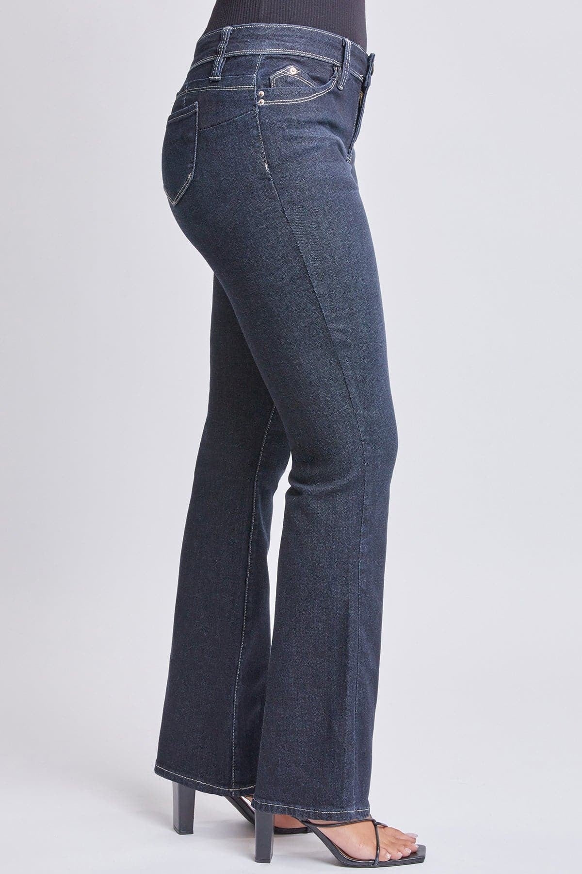 Blue jeans worn by a person on a light gray background