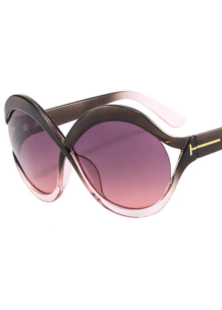 Sunglasses with pink gradient lenses and a gold accent on a white background