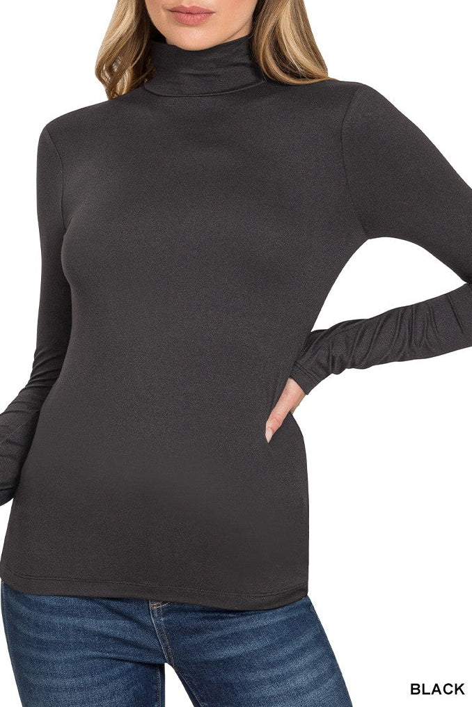 Woman wearing a black turtleneck sweater with long sleeves on a white background