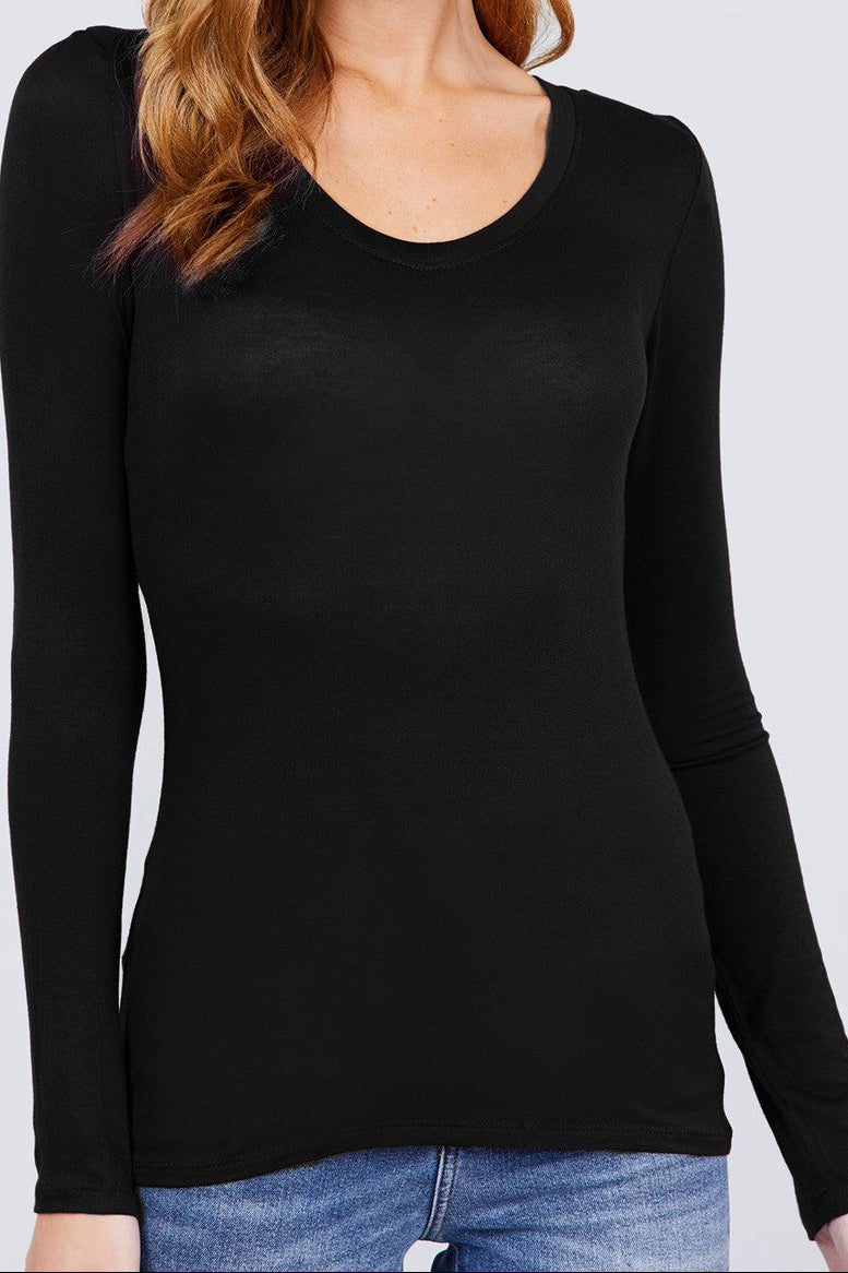 Woman wearing a black long-sleeve top against a white background